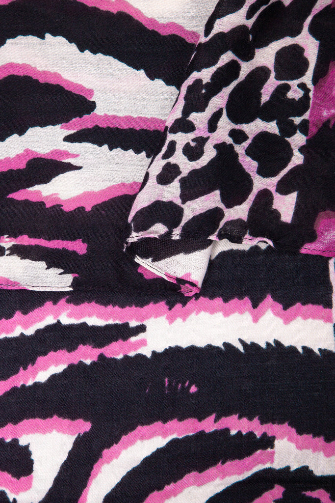 close up of the soft viscose fabric, the fuchsia colourway and mixed leopard and zebra print patterns are clearly visible