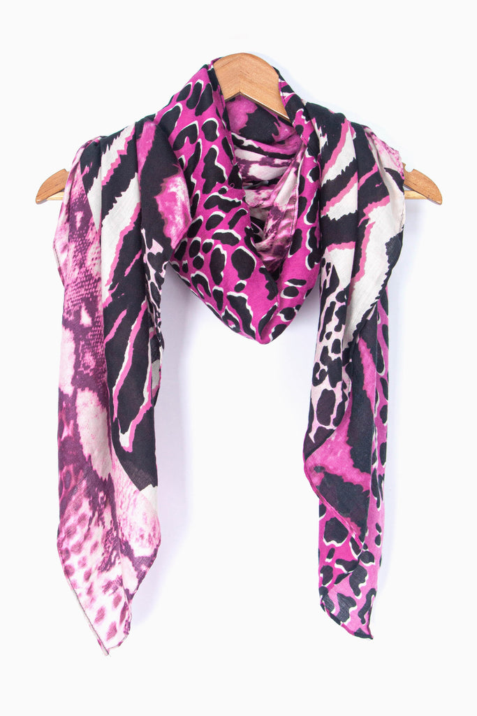 showing the scarf draped around a coat hanger, showing the all over pattern and how it would look when worn