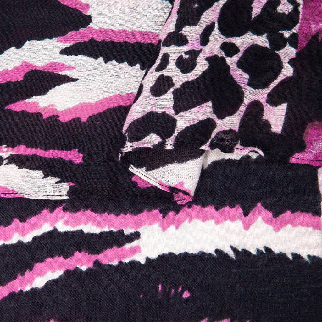 close up of the soft viscose fabric, the fuchsia colourway and mixed leopard and zebra print patterns are clearly visible