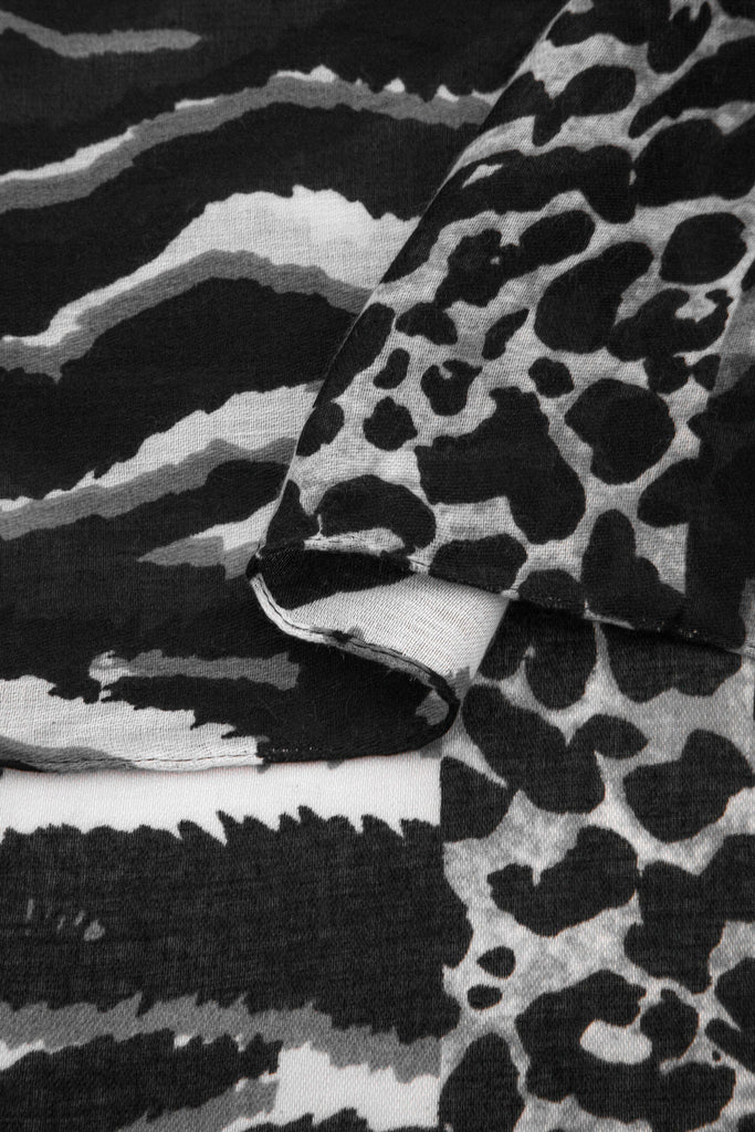 close up of the soft viscose fabric, the grey and black colourway and mixed leopard and zebra print patterns are clearly visible