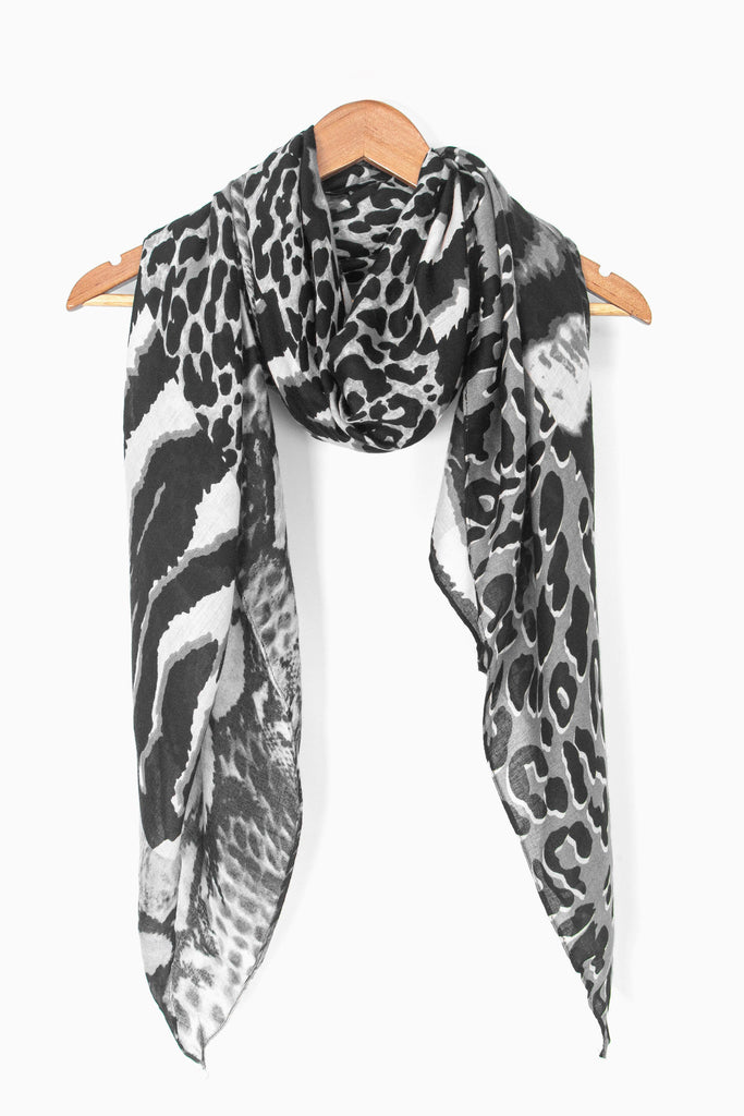 showing the scarf draped around a coat hanger, showing the all over pattern and how it would look when worn