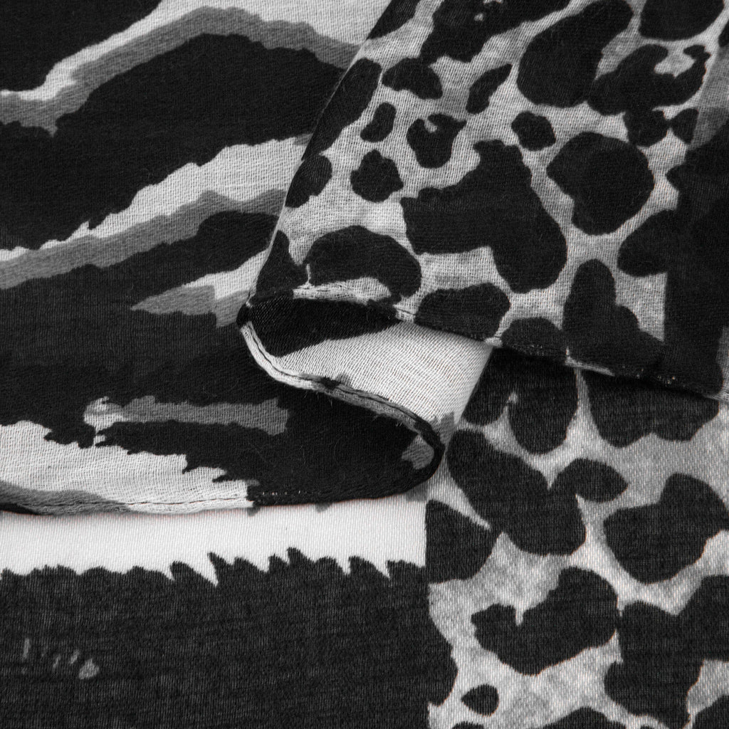 close up of the soft viscose fabric, the grey and black colourway and mixed leopard and zebra print patterns are clearly visible