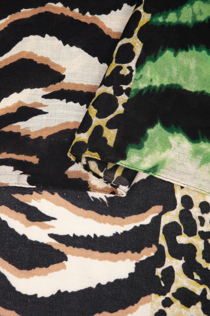 close up of the soft viscose fabric, the green colourway and mixed leopard and zebra print patterns are clearly visible