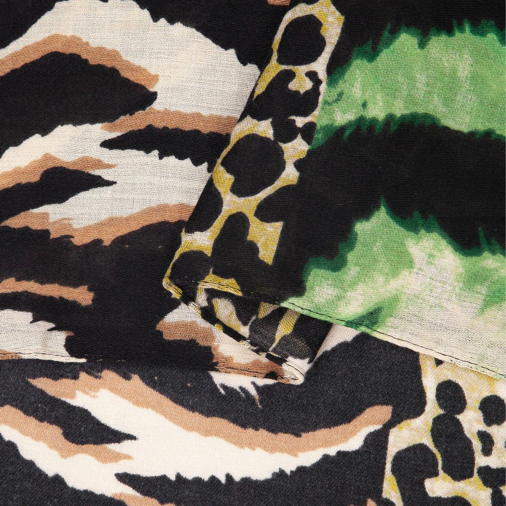 close up of the soft viscose fabric, the green colourway and mixed leopard and zebra print patterns are clearly visible