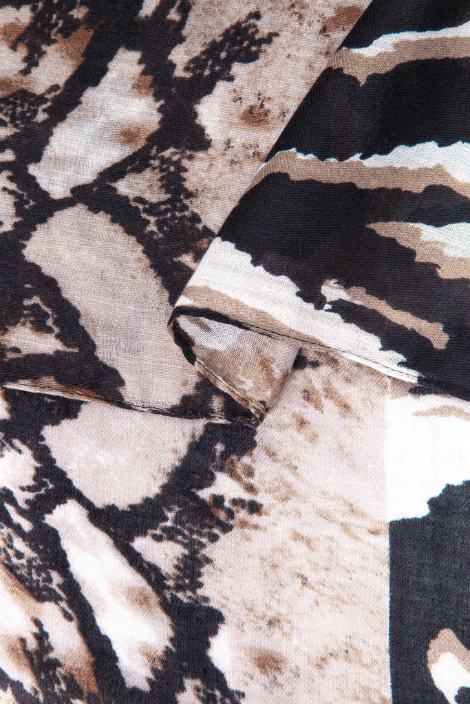 close up of the soft viscose fabric, the neutral colourway and mixed leopard and zebra print patterns are clearly visible
