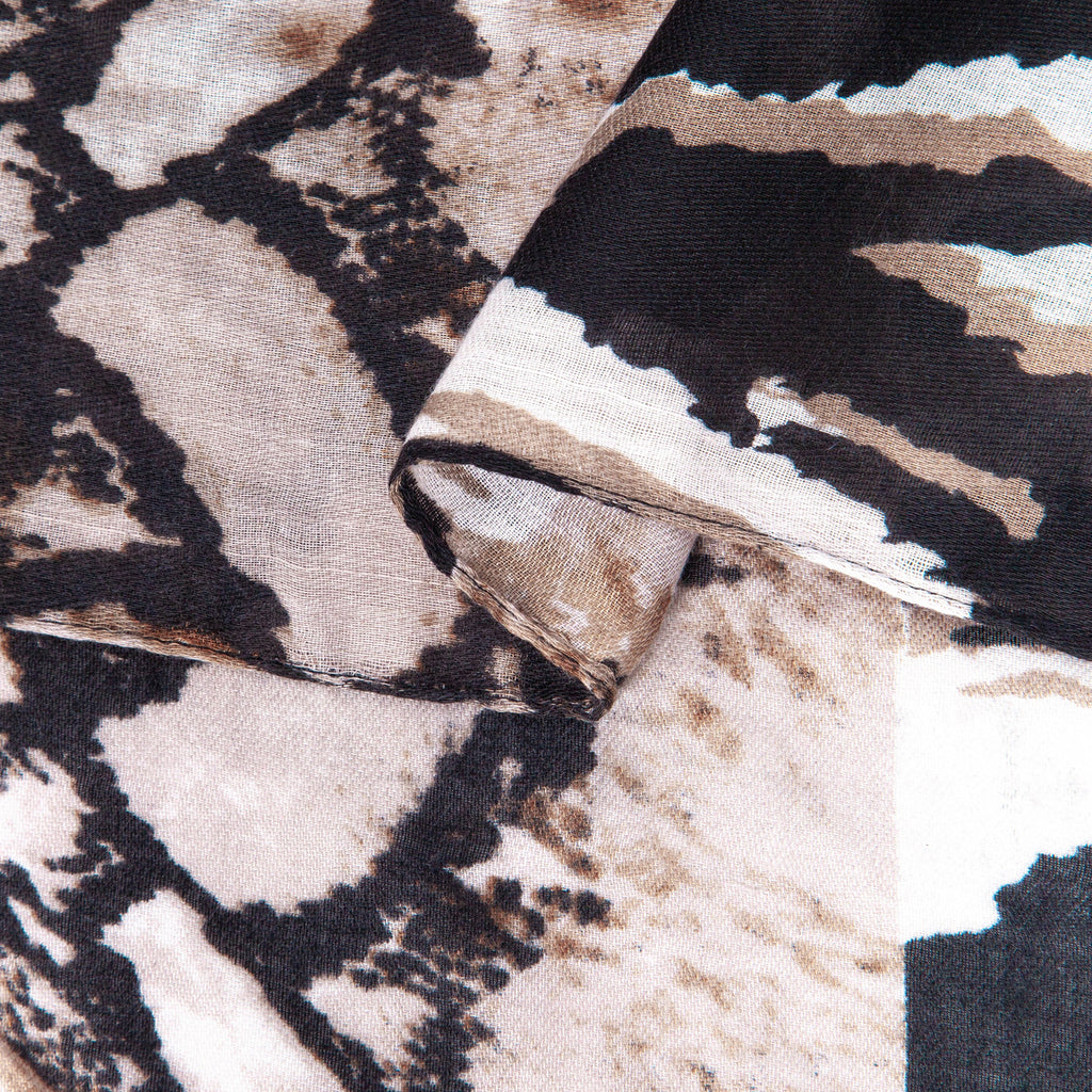 close up of the soft viscose fabric, the neutral colourway and mixed leopard and zebra print patterns are clearly visible