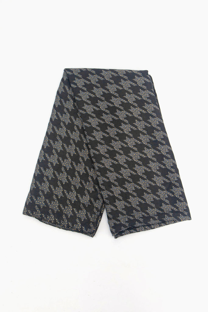 showing the scarf folded, the black design with the glittery grey houndstooth pattern is shown to cover the whole piece.