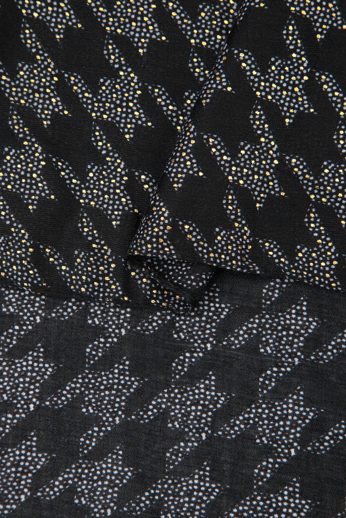 close up of the soft viscose fabric, the black colourway and houndstooth pattern is clearly visible