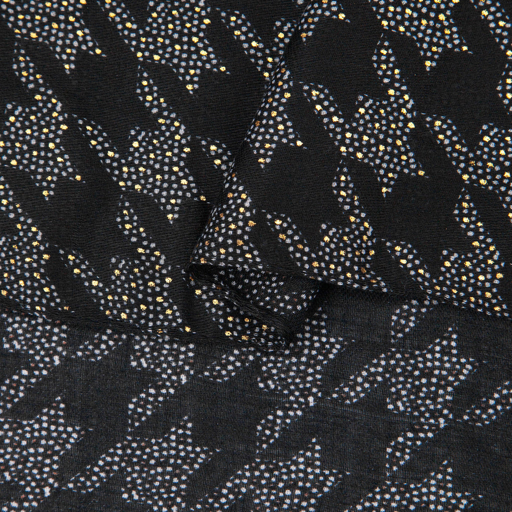close up of the soft viscose fabric, the black colourway and houndstooth pattern is clearly visible