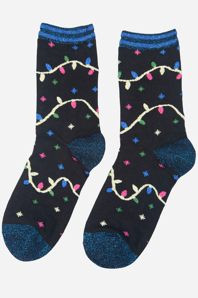 black socks with an all over pattern of stars and xmas lights, blue glitter accents