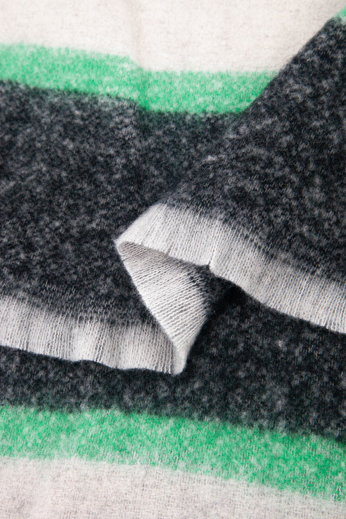 close up of the soft viscose fabric, the block stripe print pattern is clearly visible as is the fringed edge hem
