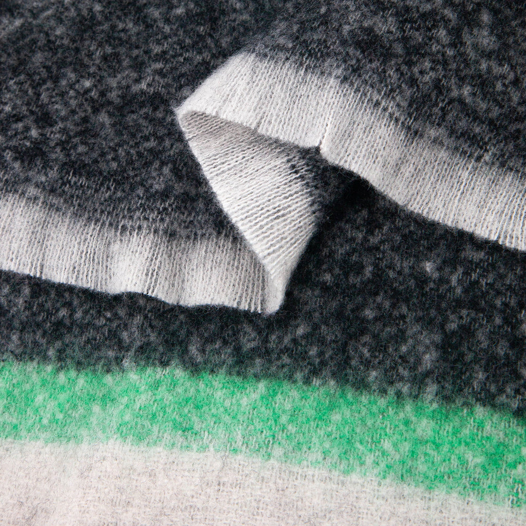 close up of the soft viscose fabric, the block stripe print pattern is clearly visible as is the fringed edge hem