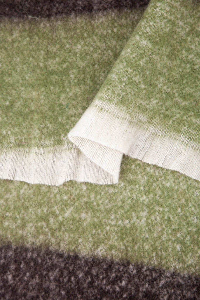 close up of the soft viscose fabric, the block stripe print pattern is clearly visible as is the fringed edge hem