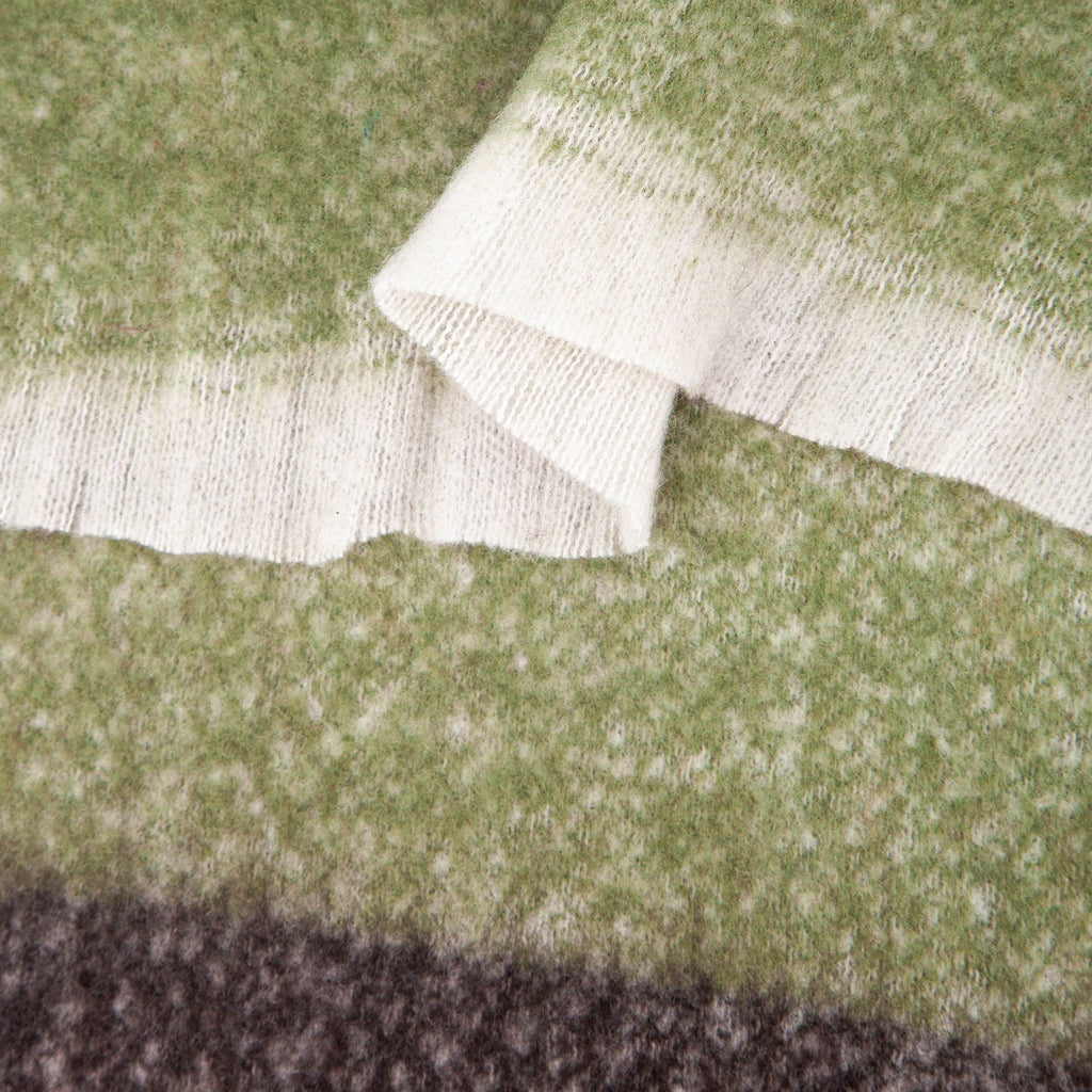 close up of the soft viscose fabric, the block stripe print pattern is clearly visible as is the fringed edge hem