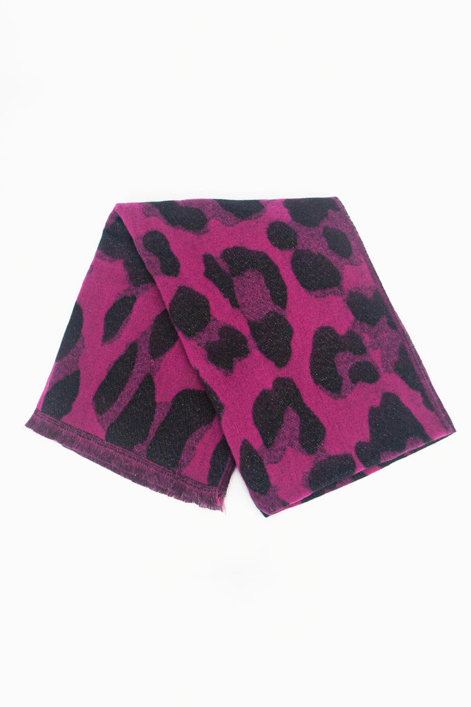 showing the scarf folded while laying flat, the pink animal print pattern and sparkly silver glitter design is shown