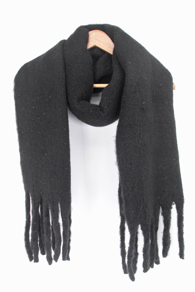showing the black and silver tinsel winter scarf draped around a coat hanger, showing how it would look when worn.