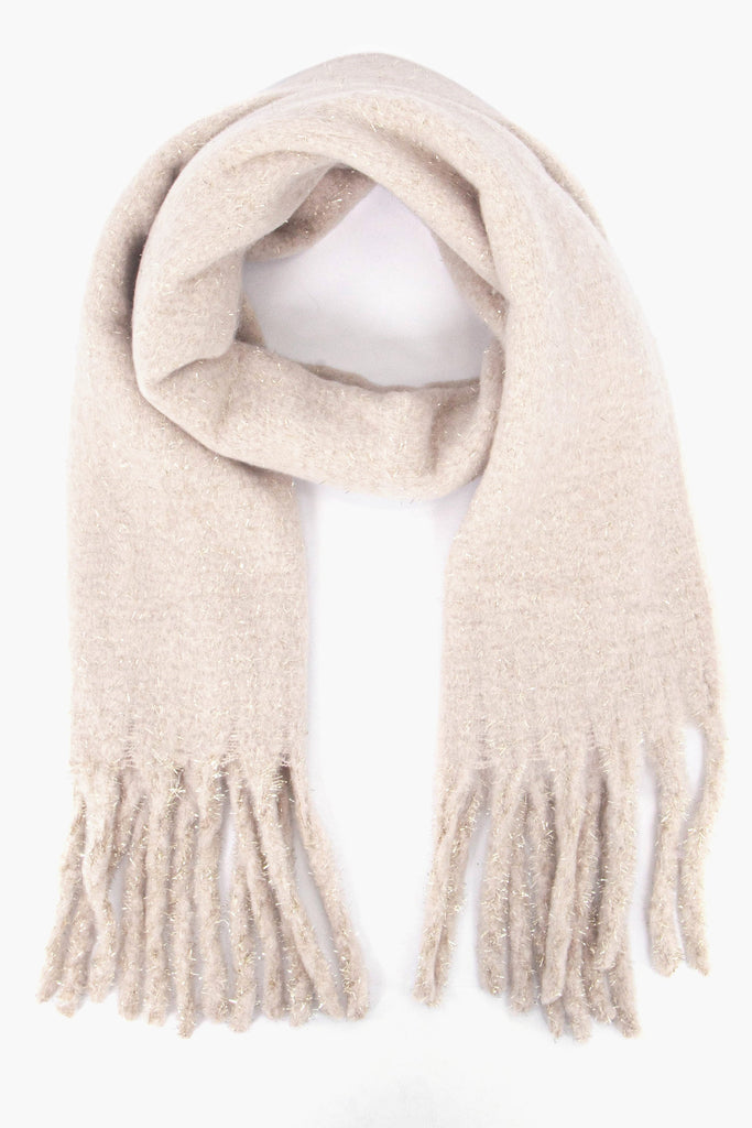 cream knitted winter scarf with tassels, the scarf has a tinsel effect sparkly material