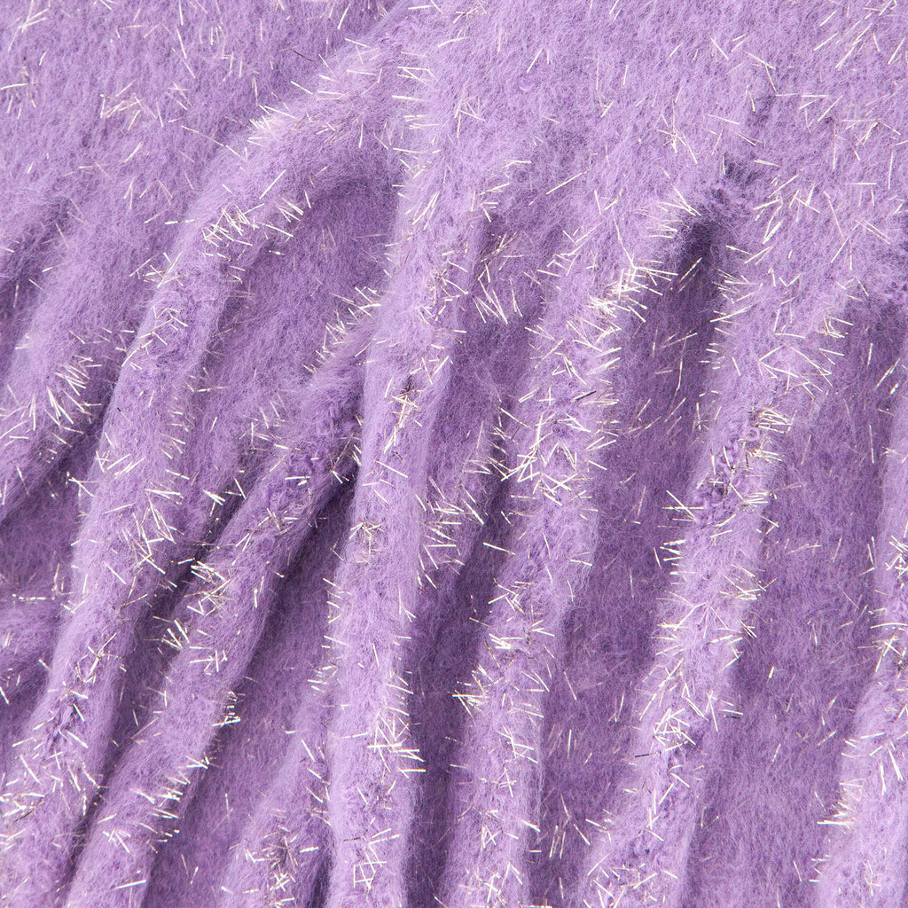 close up of the knitted material of the winter blanket scarf, the silver tinsel fibres are clearly shown