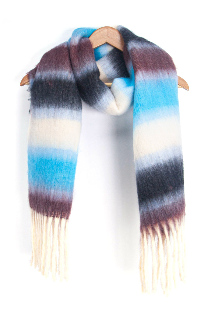 showing the blue, black and grey striped winter scarf draped around a coat hanger, showing how it would look when worn