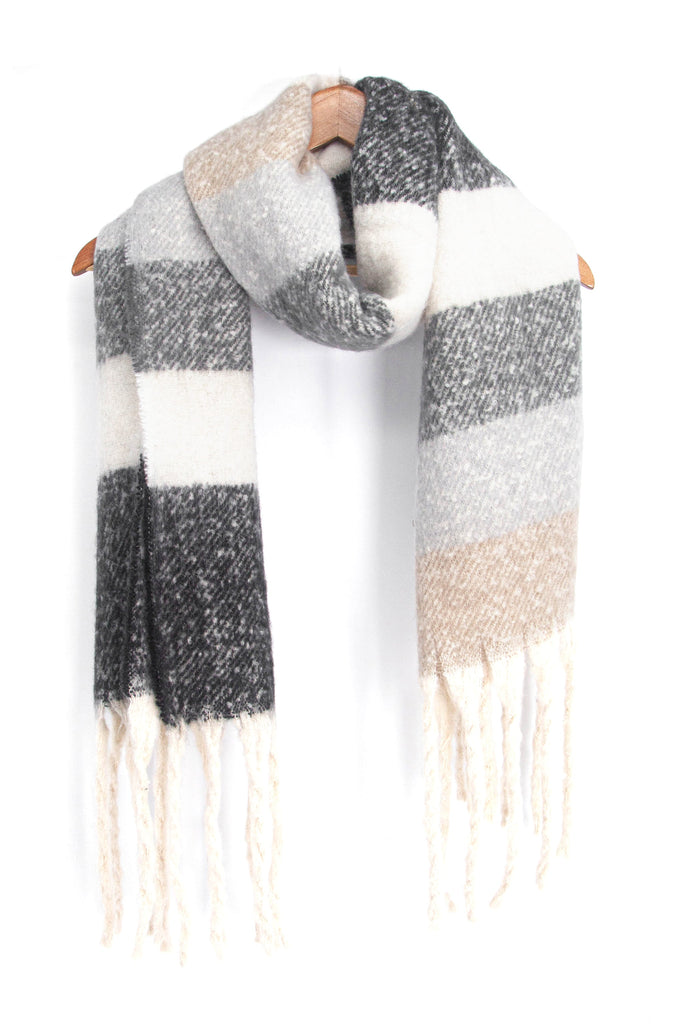 showing the grey, white and beige striped winter scarf draped around a coat hanger, showing how it would look when worn