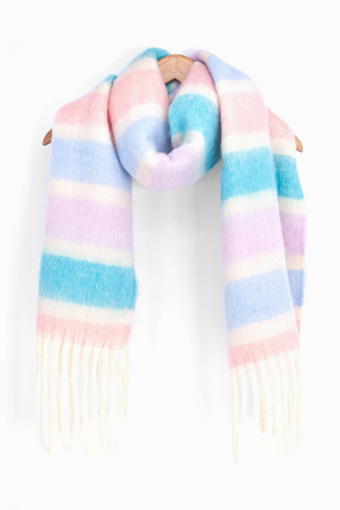 showing the blue, lilac, pink and cream winter scarf draped around a coat hanger, showing how it would look when worn