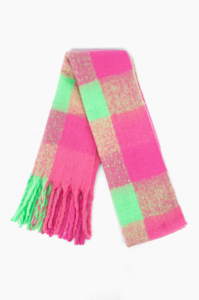 showing the scarf folded while laying flat, the check pattern is highlighted. there are pink and green tones visible in the design.