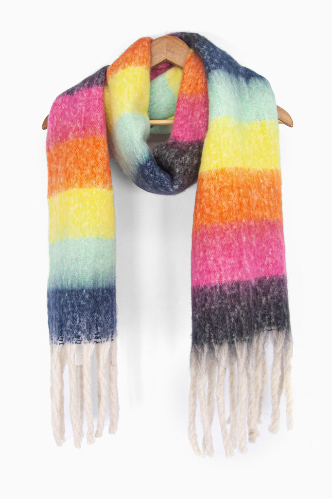 showing the rainbow stripe multi colour block winter scarf draped around a coat hanger, showing how it would look when worn.
