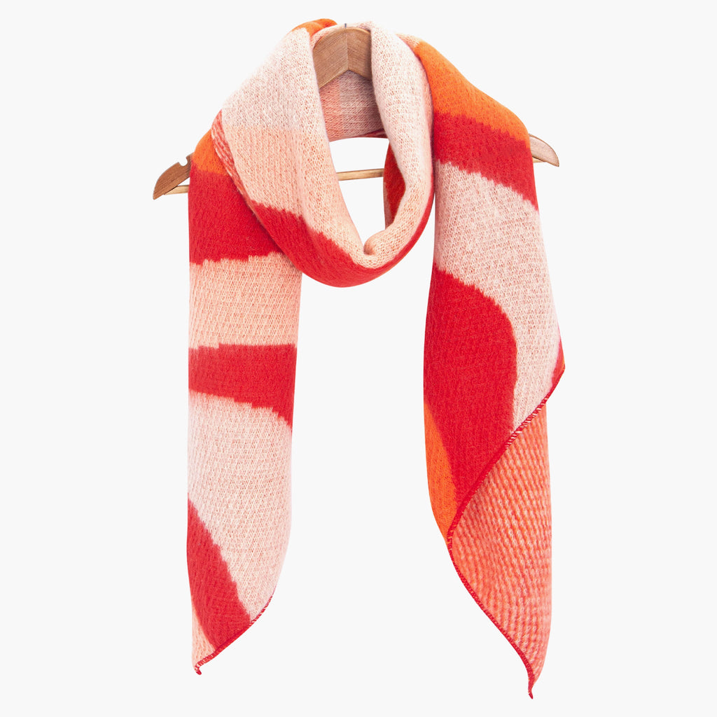 ramona-orange-red-waves-heavyweight-scarf-draped-on-coat-hanger