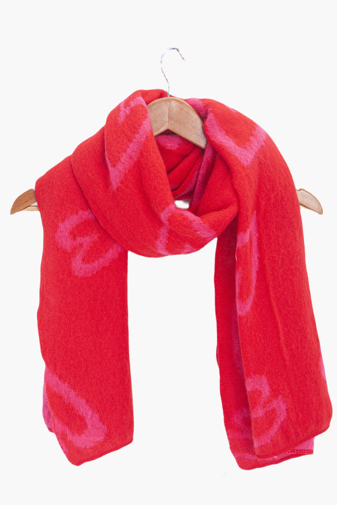 zuri-red-pink-sketched-hearts-heavyweight-scarf-draped-on-coat-hanger