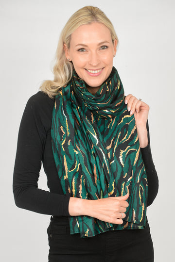 model wearing a green and gold foil zebra print scarf