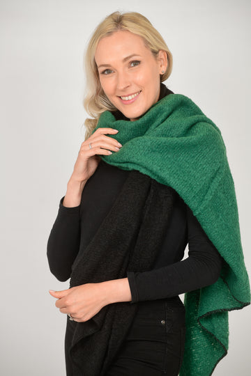 model wearing a half green and half black winter scarf