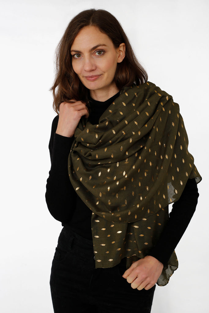 model wearing a khaki green and gold foil print scarf