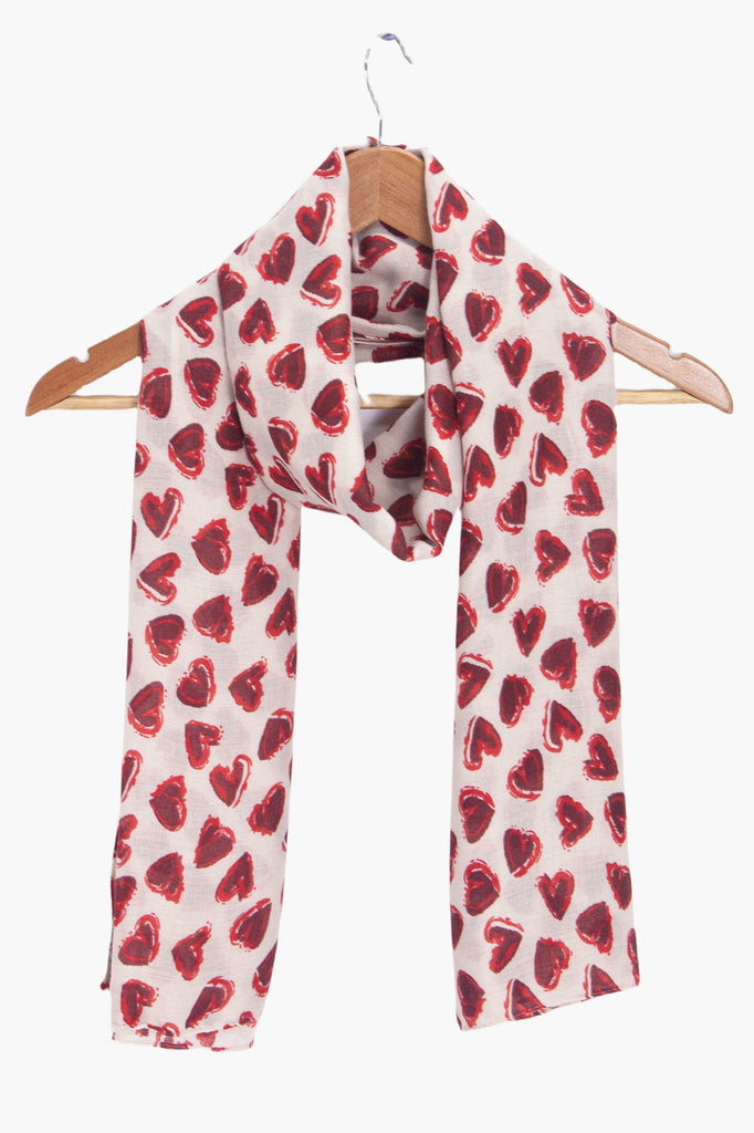 kara-white-red-hearts-lightweight-scarf-draped-on-coat-hanger
