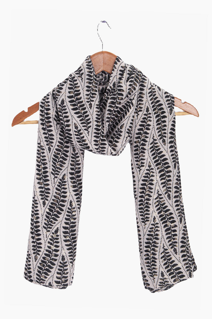 clover-cream-fern-leaf-lightweight-scarf-draped-on-coat-hanger