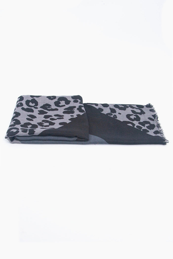 side view of the scarf when folded, showing the texture and thickness of the material. this scarf is lightweight