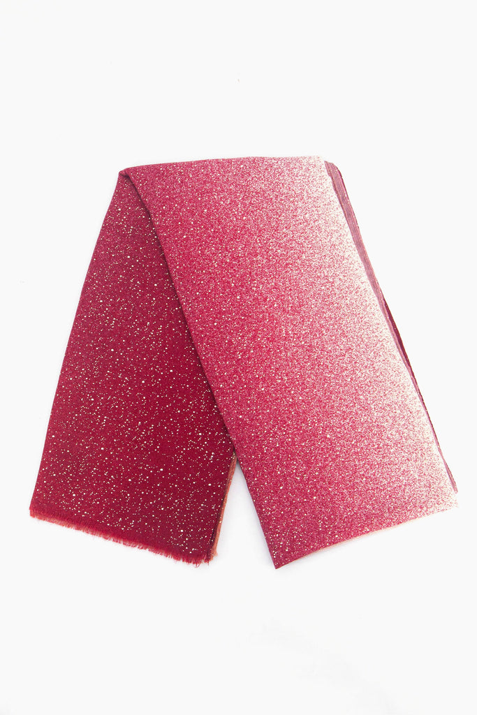 showing the scarf folded, the fuchsia pink ombre and silver foil speckle pattern is shown to cover the whole scarf.