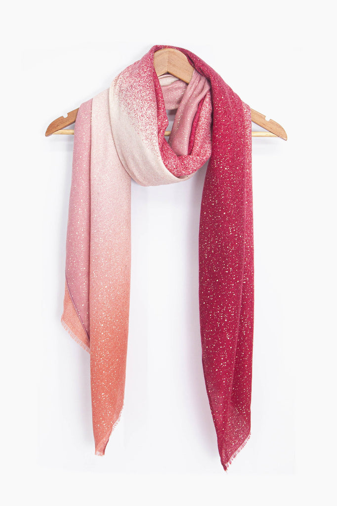 showing the scarf draped around a coat hanger, showing the all over pattern and how it would look when worn