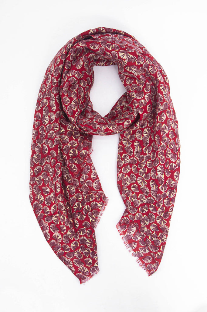 red lightweight scarf with an all over retro fan print pattern, the fans are open and have metallic foil highlights