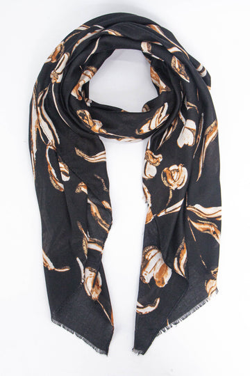 black scarf with a large floral pattern in cream and tan with gold glitter accents throughout