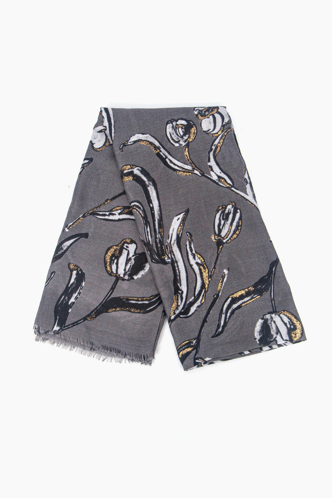 showing the scarf folded, the grey and white bold floral pattern with the gold foil accents is shown to cover the whole scarf.