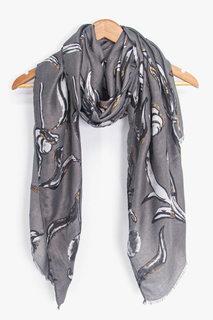 showing the scarf draped around a coat hanger, showing the all over pattern and how it would look when worn