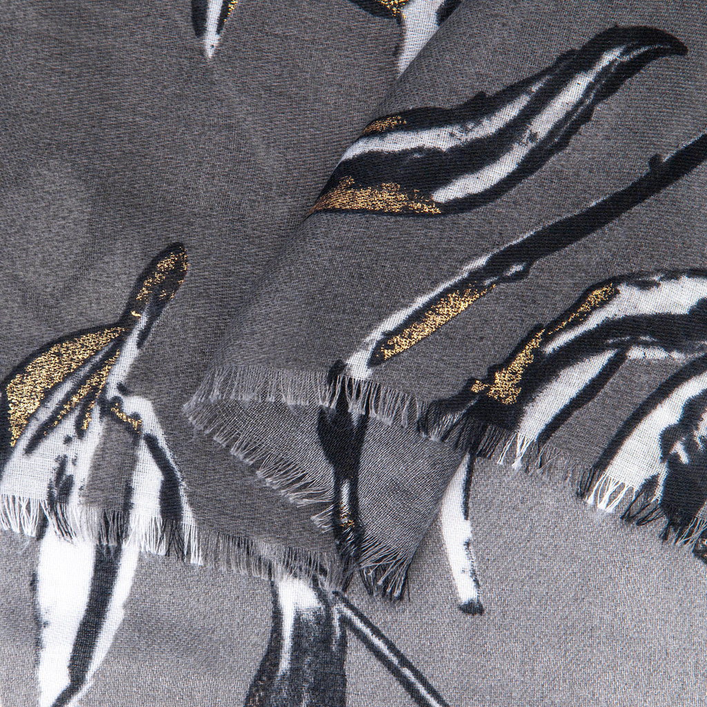 close up of the soft viscose fabric, the grey and white colourways are clearly visible as are the metallic gold accents.