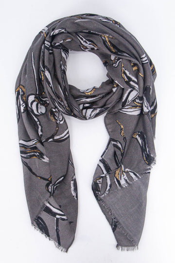 grey scarf with a large floral pattern in black and white with gold glitter accents throughout