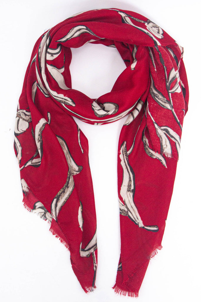 red scarf with a large floral pattern in cream with gold glitter accents throughout