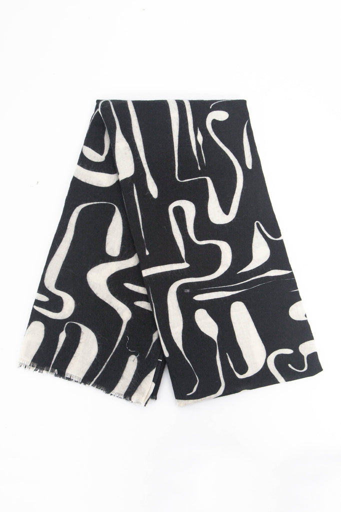 showing the scarf folded, the black and white abstract pattern is shown to cover the full design