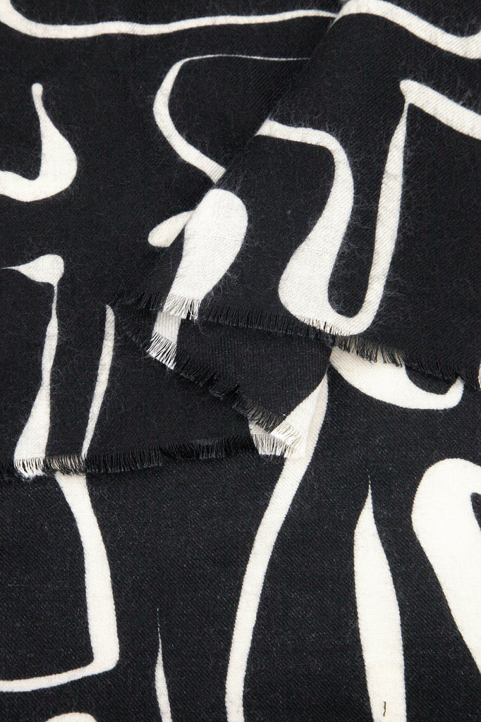 close up of the soft viscose fabric, the black and white colourways are clearly visible