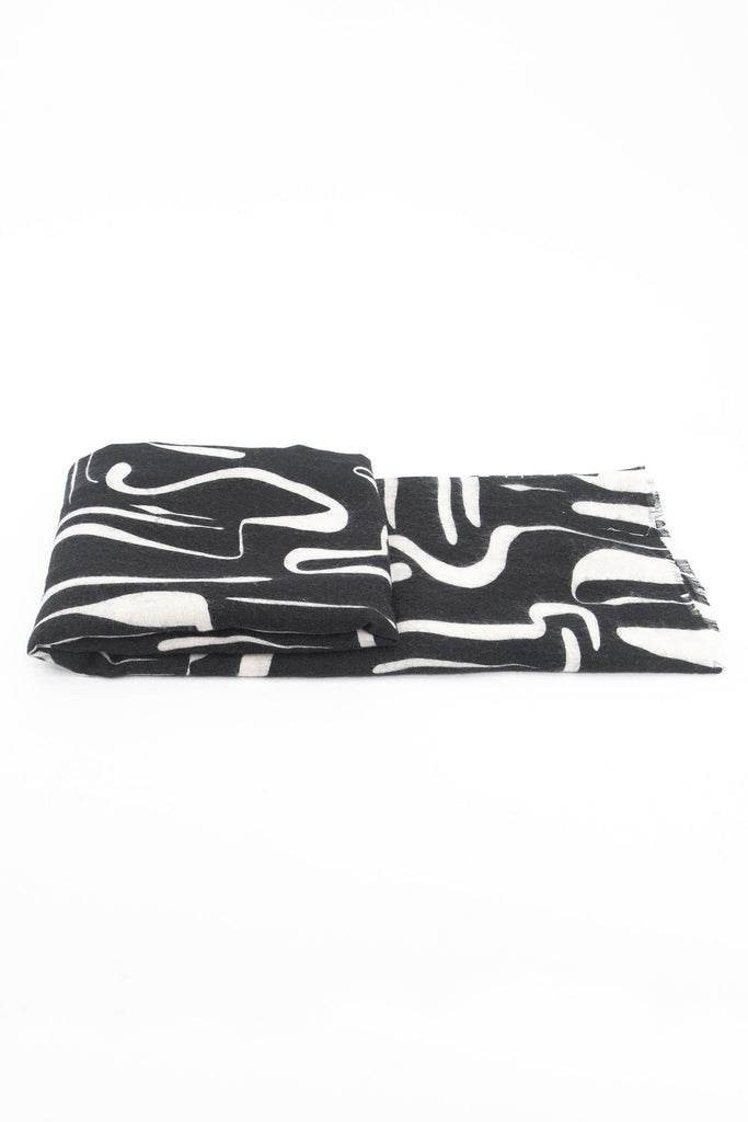 side view of the scarf when folded, showing the texture and thickness of the material. this scarf is lightweight