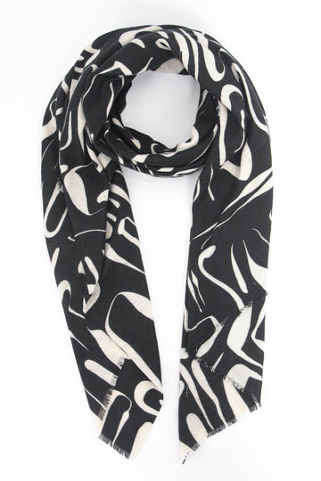 black scarf with a contrasting white abstract print pattern all over