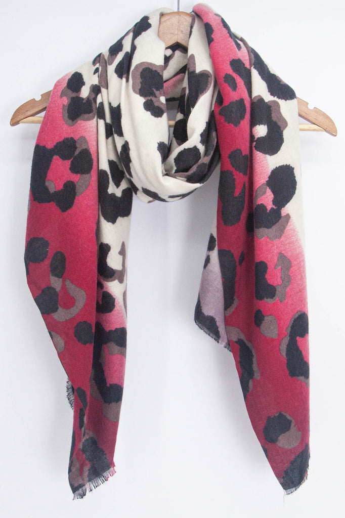 showing the fuchsia and cream leopard print scarf draped around a coat hanger, showing how it would look when worn
