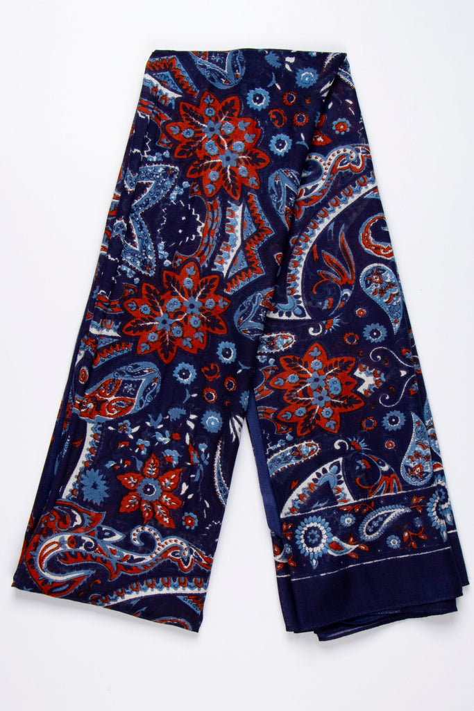 showing the scarf folded, the navy blue and coral mosaic pattern is shown, the scarf also has a plain border around the outer edge which is navy blue the same as the base of the design